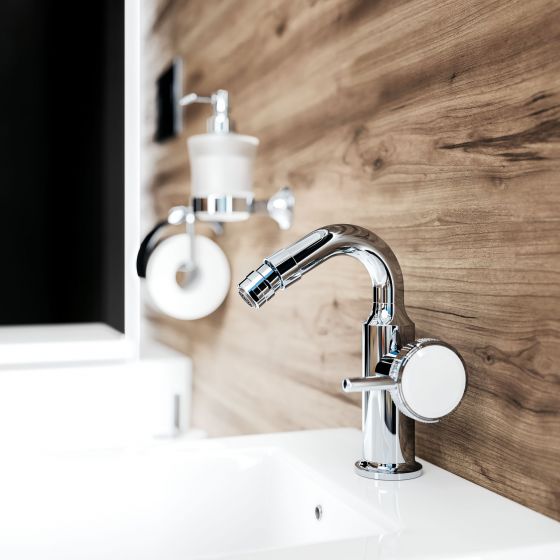 Jörger bidet mixer tap in chrome from the Valencia series, lever handle with white crystal, in the background: accessories, soap dispenser, toilet roll