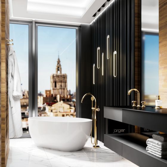 Valencia in the exclusive finish sunshine design by Jörger in a modern bathroom interior: the free-standing bath fitting, the washbasin tap and accessories shine in tasteful surroundings. The overall effect of the bathroom design: luxurious, aesthetic and