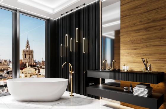 Valencia in the exclusive finish sunshine design by Jörger in a modern bathroom interior: the free-standing bath fitting, the washbasin tap and accessories shine in tasteful surroundings. The overall effect of the bathroom design: luxurious, aesthetic and