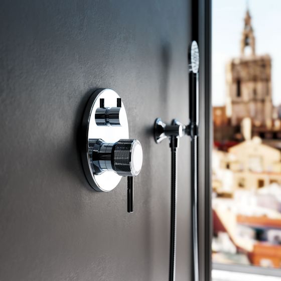Jörger Valencia shower combination set in cool, polished chrome, the thermostat handle with white crystal in a finely  fluted rim made of chrome is the focal point.